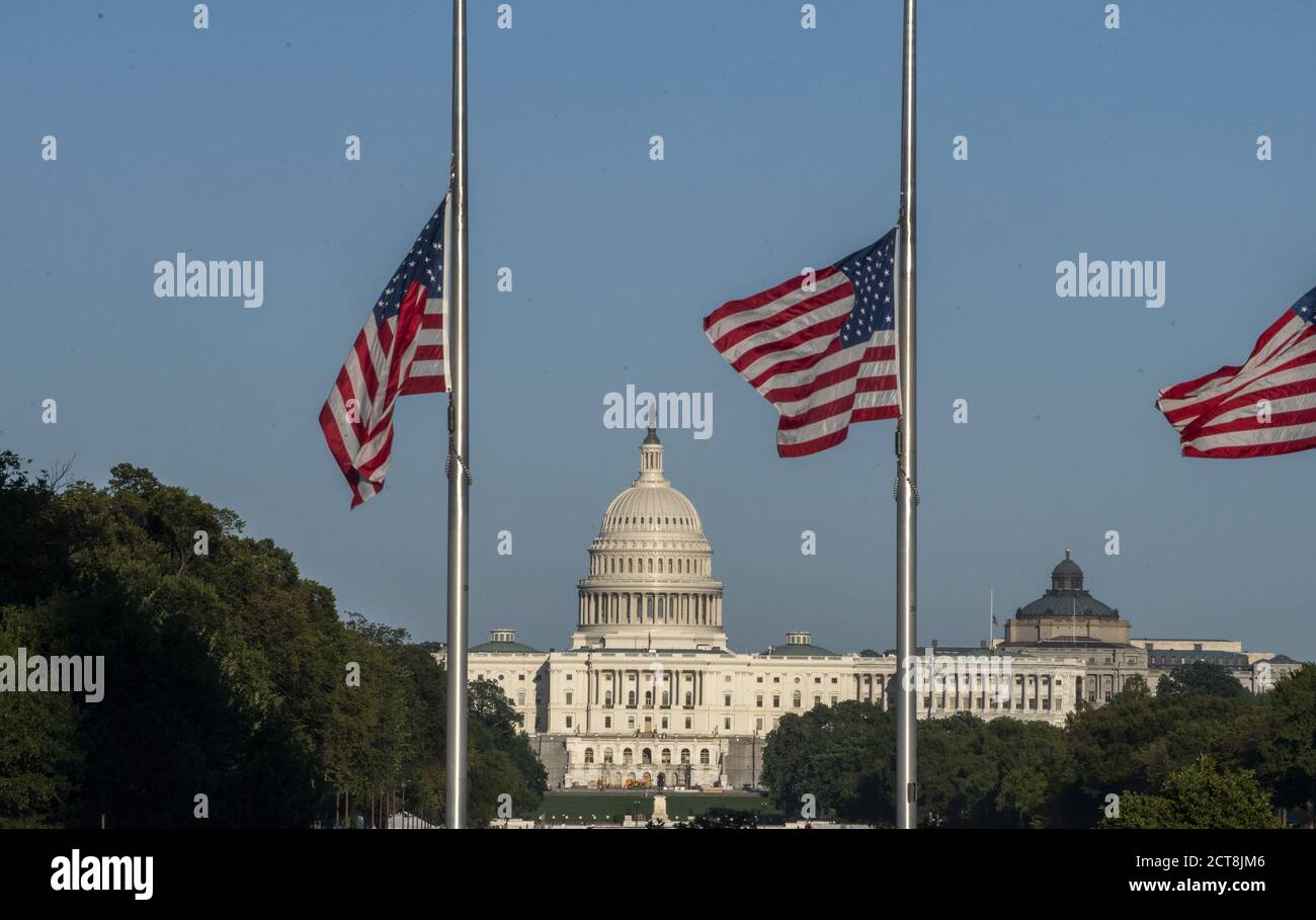 Washington, United States. 21st Sep, 2020. The U.S. Capitol is seen between the flags are at half mast at the Washington Monument in honor of Supreme Court Justice Ruth Bader Ginsburg on Monday, September 21, 2020 in Washington, DC. Ginsburg died on Saturday, September 19th and will lie in state at the U.S. Capitol on Friday, September 25, 2020. Photo by Pat Benic/UPI Credit: UPI/Alamy Live News Stock Photo