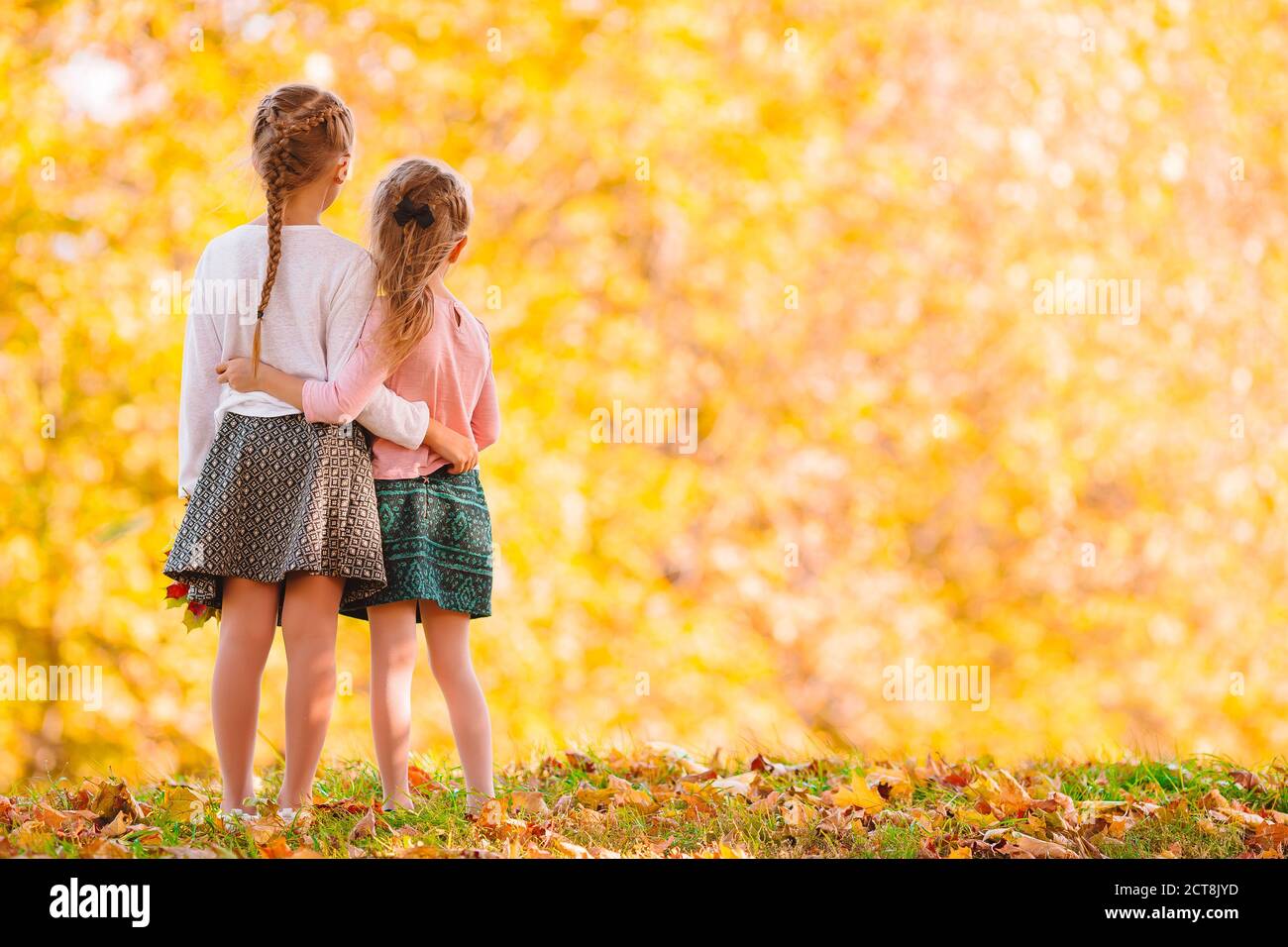 Little adorable girls outdoors at warm sunny autumn day Stock Photo - Alamy