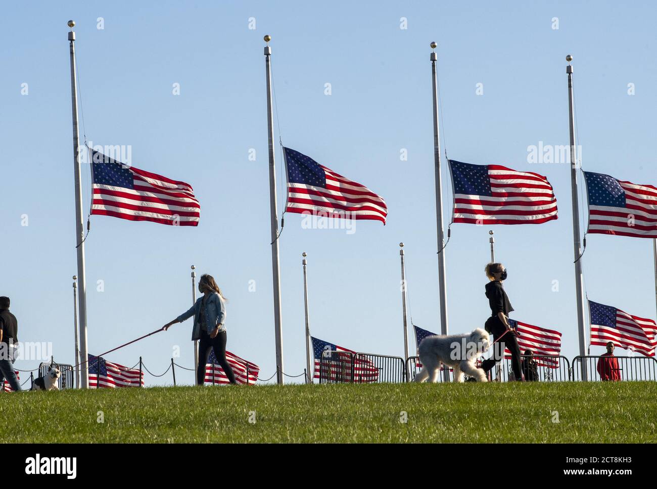 Washington, United States. 21st Sep, 2020. Residents walk their dogs as flags are at half mast at the Washington Monument in honor of Supreme Court Justice Ruth Bader Ginsburg on Monday, September 21, 2020 in Washington, DC. Ginsburg died on Saturday, September 19th and will lie in state at the U.S. Capitol on Friday, September 25, 2020. Photo by Pat Benic/UPI Credit: UPI/Alamy Live News Stock Photo