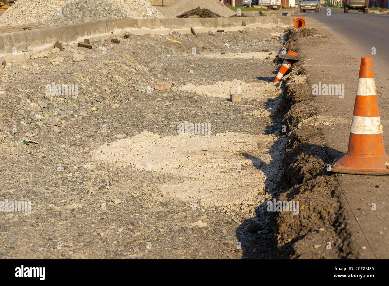 curb formation and traffic cones at the edge of the carriageway, selective focus Stock Photo