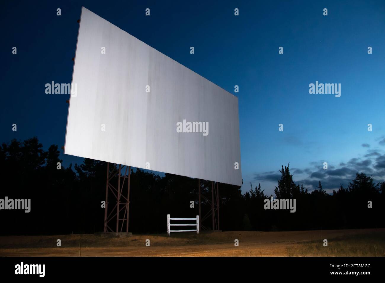 Blank white drive-in movie screen; evening twilight skies in the background. Stock Photo