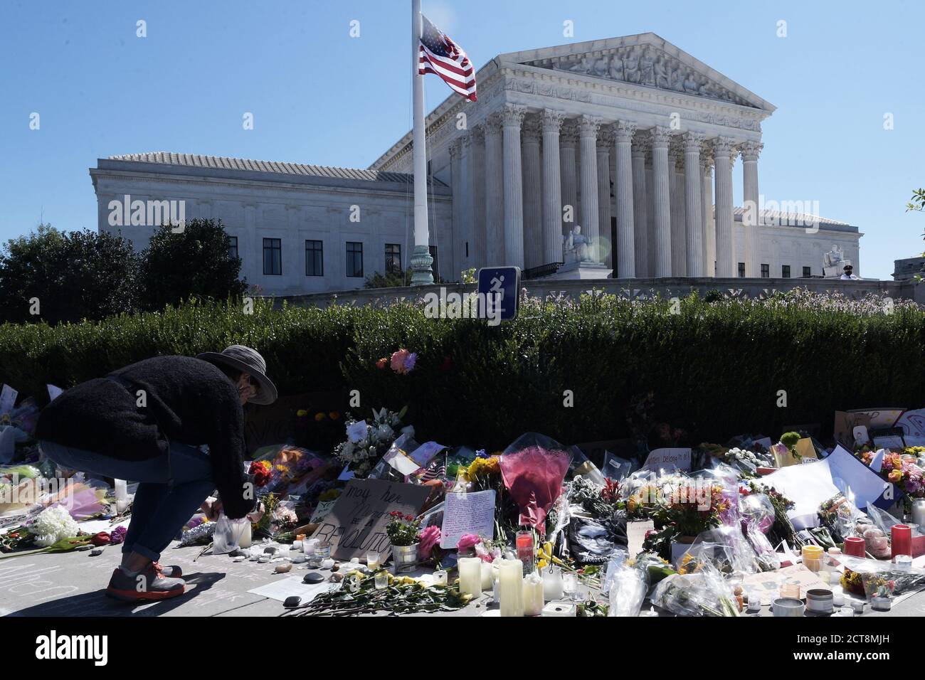 Washington, United States. 21st Sep, 2020. A man lays flowers during a vigil honoring the life of the late Supreme Court Justice Ruth Bader Ginsburg, Dozens of people lay flowers and pay respects for the death of the US Supreme Court of Justice Ruth Bader Ginsburg. Credit: SOPA Images Limited/Alamy Live News Stock Photo