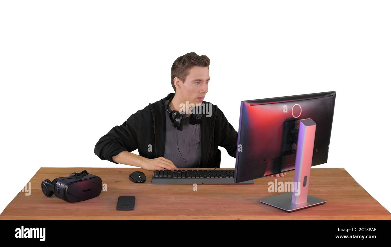 Nervous man watching video games on a PC computer on white backg Stock Photo