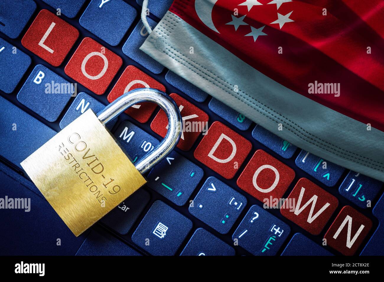 Singapore COVID-19 coronavirus lockdown restrictions concept illustrated by padlock on laptop red alert keyboard buttons and face mask with Singaporea Stock Photo