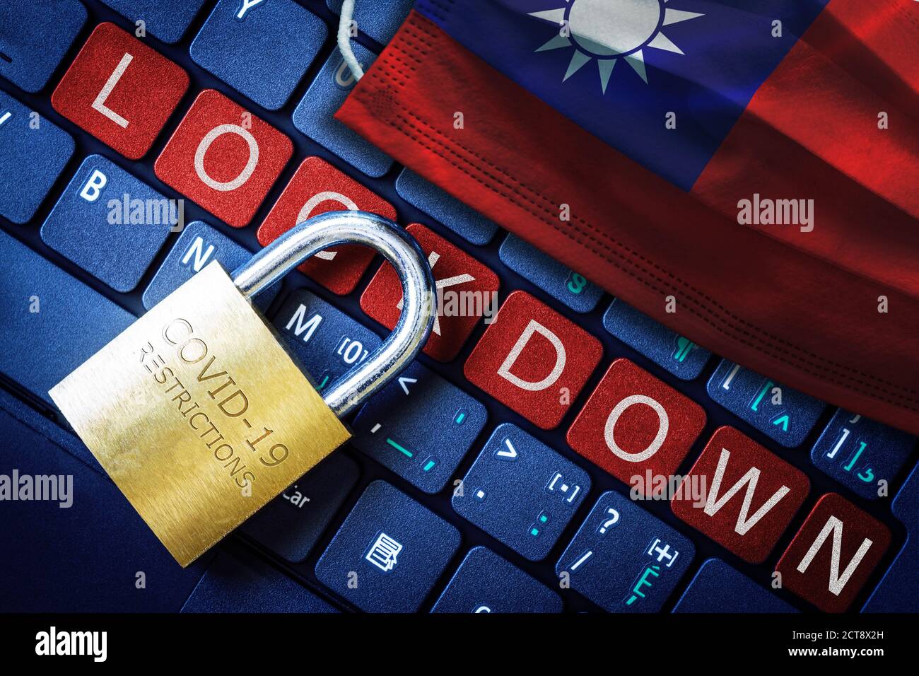 Taiwan COVID-19 coronavirus lockdown restrictions concept illustrated by padlock on laptop red alert keyboard buttons and face mask with Taiwanese fla Stock Photo