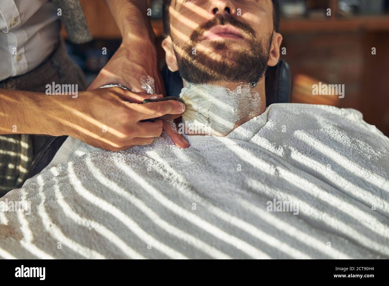 Young man getting shaving cream smeared over his neck Stock Photo Alamy