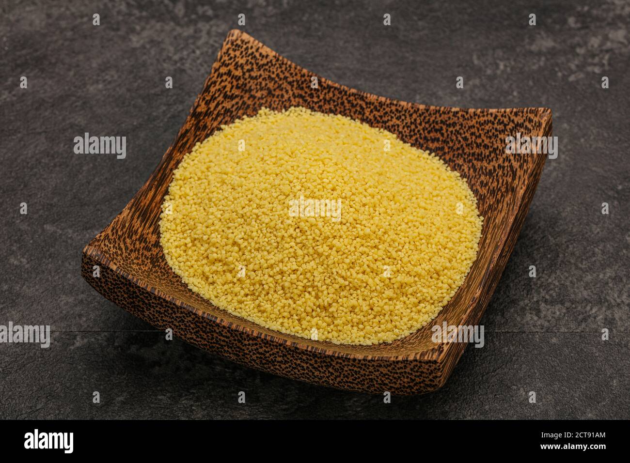 Raw cous cous heap in the bowl for cooking Stock Photo Alamy
