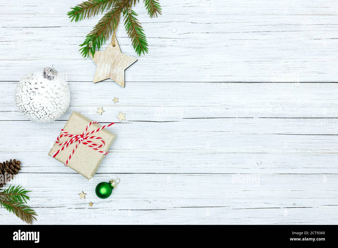 christmas decorations, balls and handmade paper gift box on painted white wooden background Stock Photo