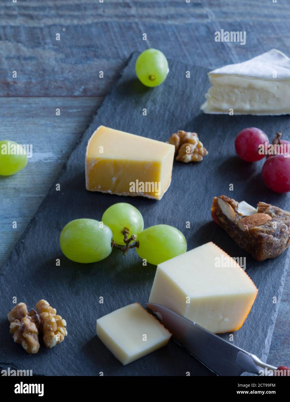 Cheese platter witch assorted cheese and grapes Stock Photo