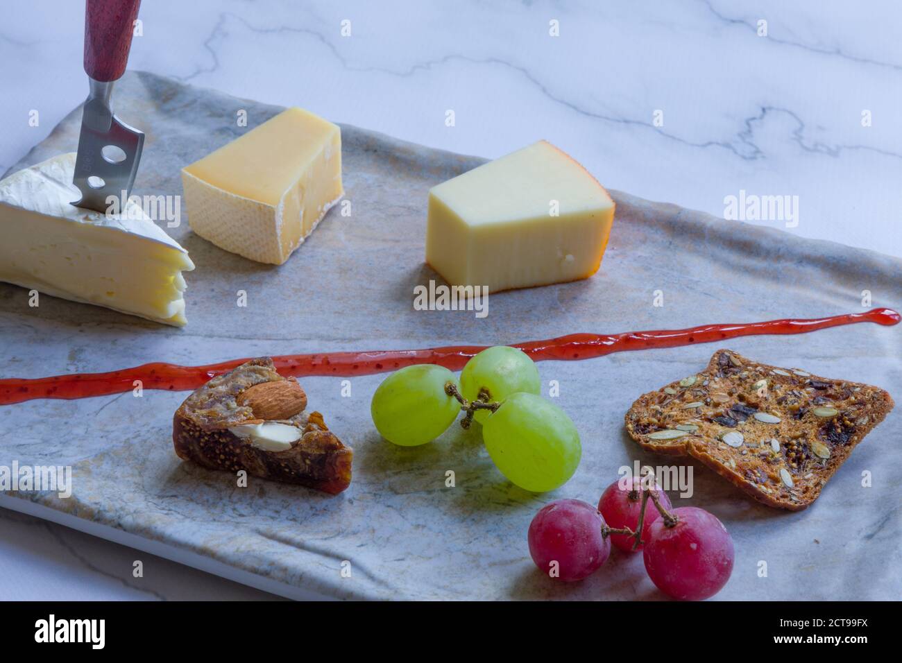 Cheese platter witch assorted cheese and grapes Stock Photo