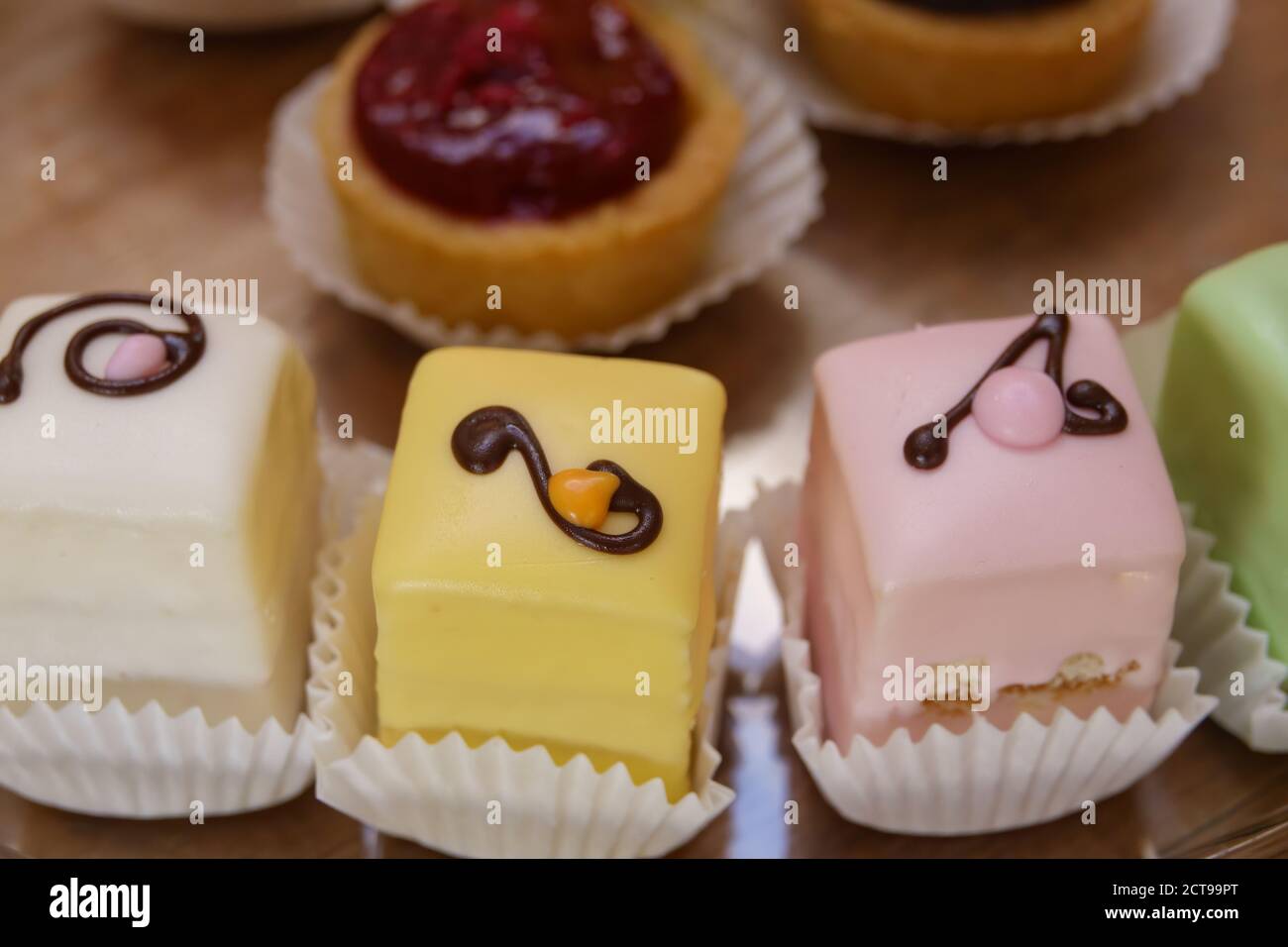 Iced mini cakes named Petit four glace. Delicious for a high tea or as dessert. Stock Photo