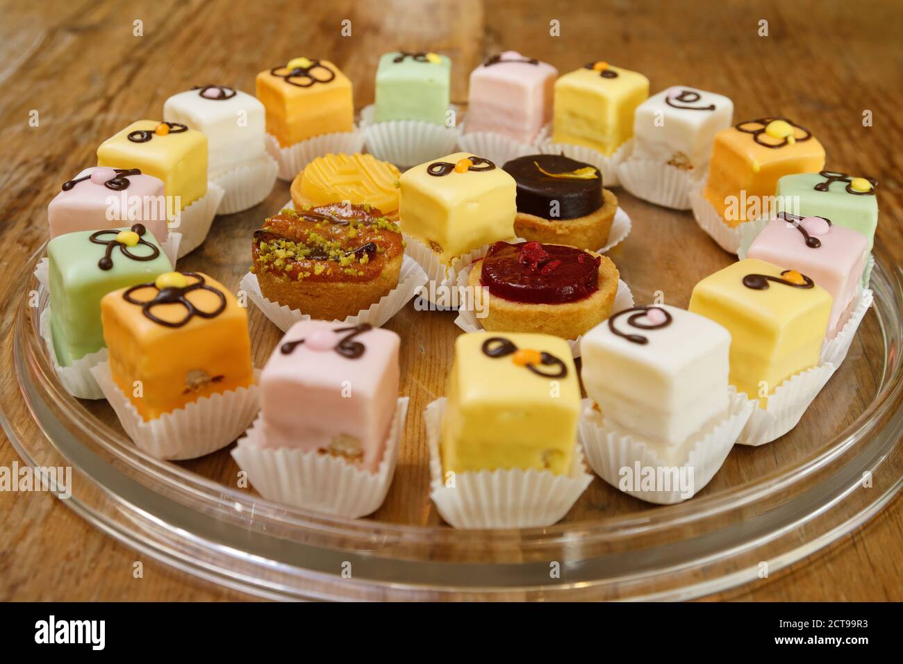 Iced mini cakes named Petit four glace. Delicious for a high tea or as dessert. Stock Photo