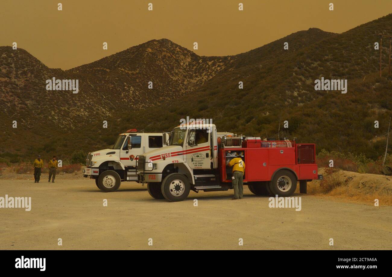 Juniper Hills, United Sates. 22nd Sep, 2020. Firefighters rest on the Angeles Crest Highway as smoke from the Bobcat Fire envelops the San Gabriel Mountains in Juniper Hills, California on Monday, September, 21, 2020. The wildfire continues into its 16th day, burning more than 106 thousand acres. Full containment is not expected until October 30th. Photo by Jim Ruymen/UPI Credit: UPI/Alamy Live News Stock Photo