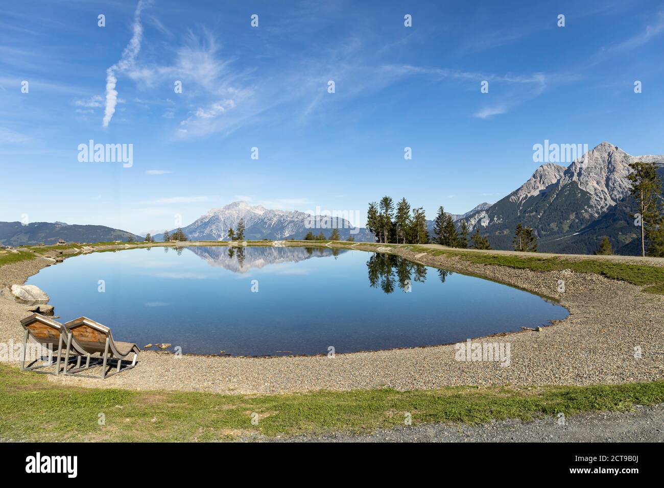 Prinzensee lake in Austria in the region of Hochkoenig Salzburg. The mountains in the background reflect in the mirro surface of the lake. A car is pa Stock Photo