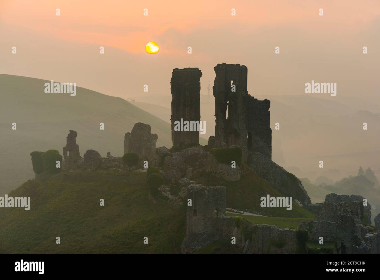 Corfe Castle, Dorset, UK.  22nd September 2020.  UK Weather.  A misty sunrise at Corfe Castle in Dorset with the rising sun obscured by misty low cloud on the autumn solstice.  Picture Credit: Graham Hunt/Alamy Live News Stock Photo