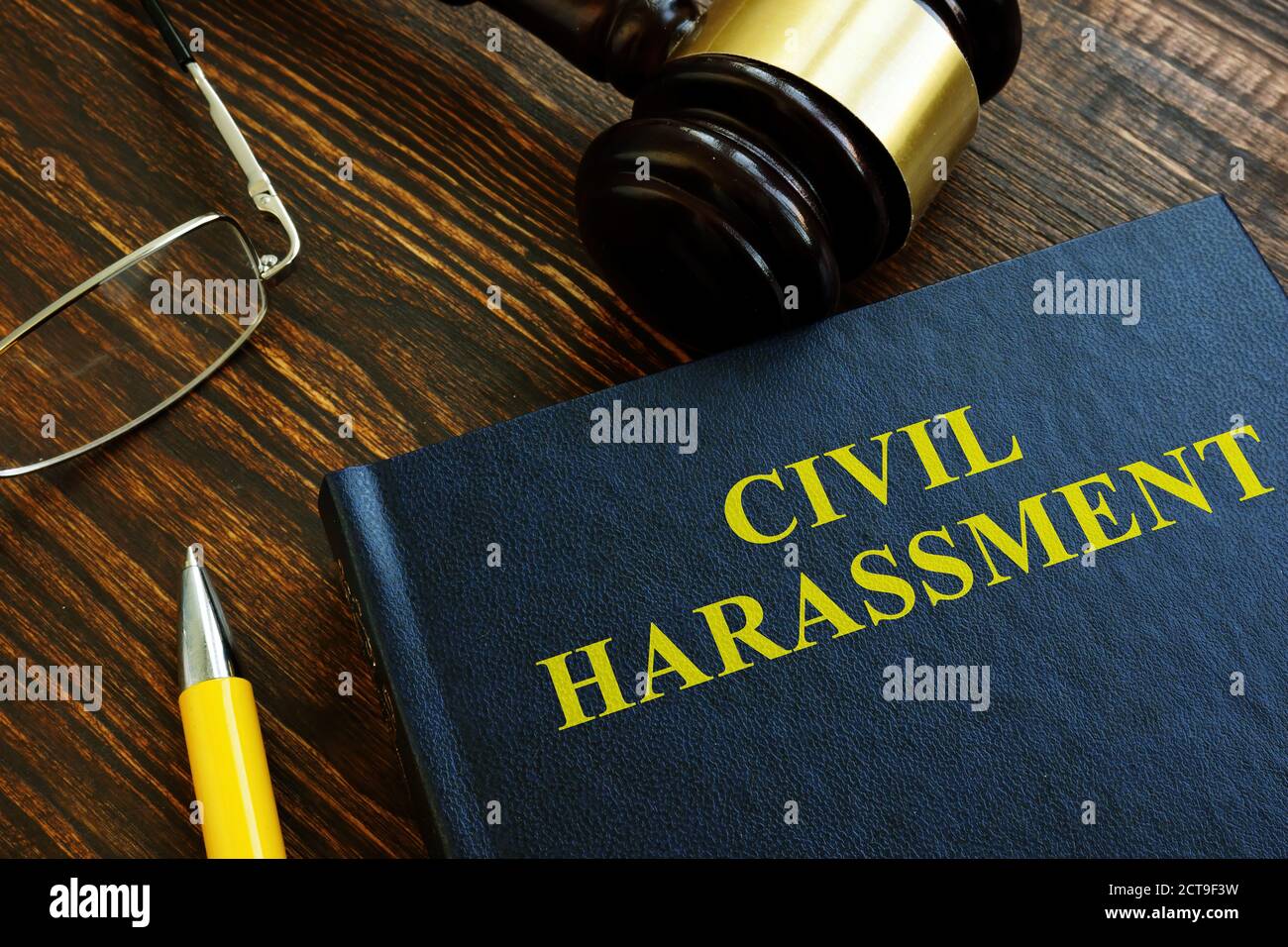 Civil harassment book with dark wooden gavel. Stock Photo