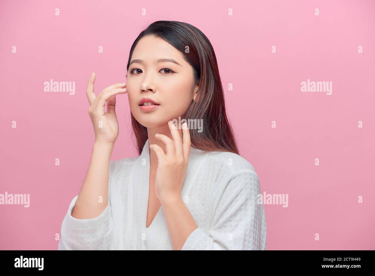 Portrait of beautiful woman with natural make up touching her face ...