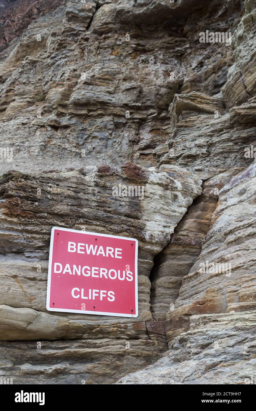 Dangerous cliffs warning sign pictured at the foot of the cliffs