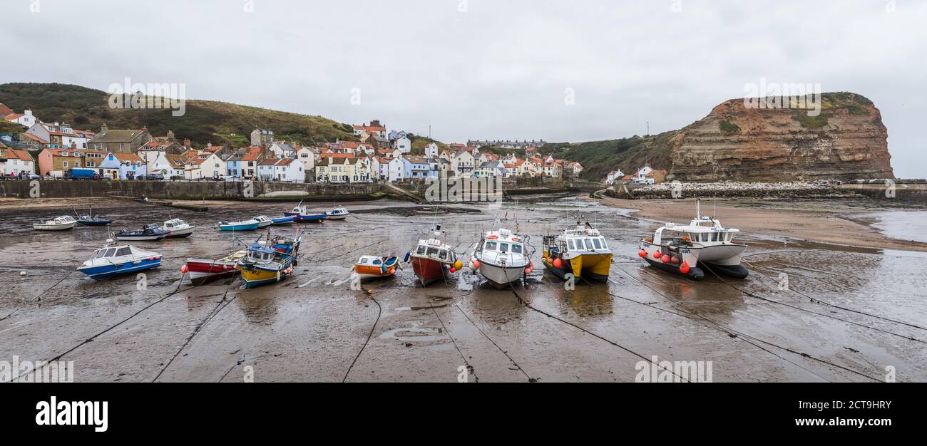 Fishing boats in Staithes harbour at low tide captured as a multi image ...