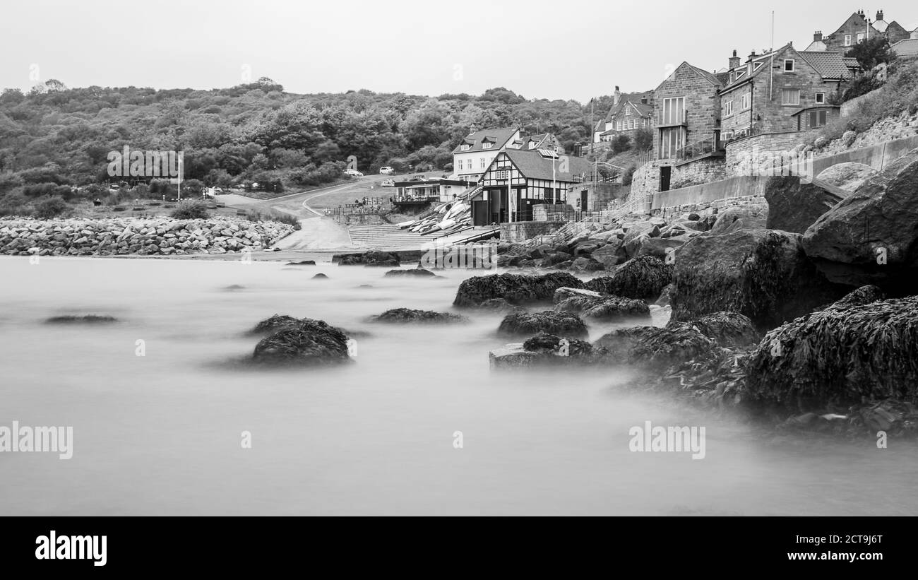 Runswick Bay long exposure in monochrome seen in September 2020 as the tide comes in. Stock Photo
