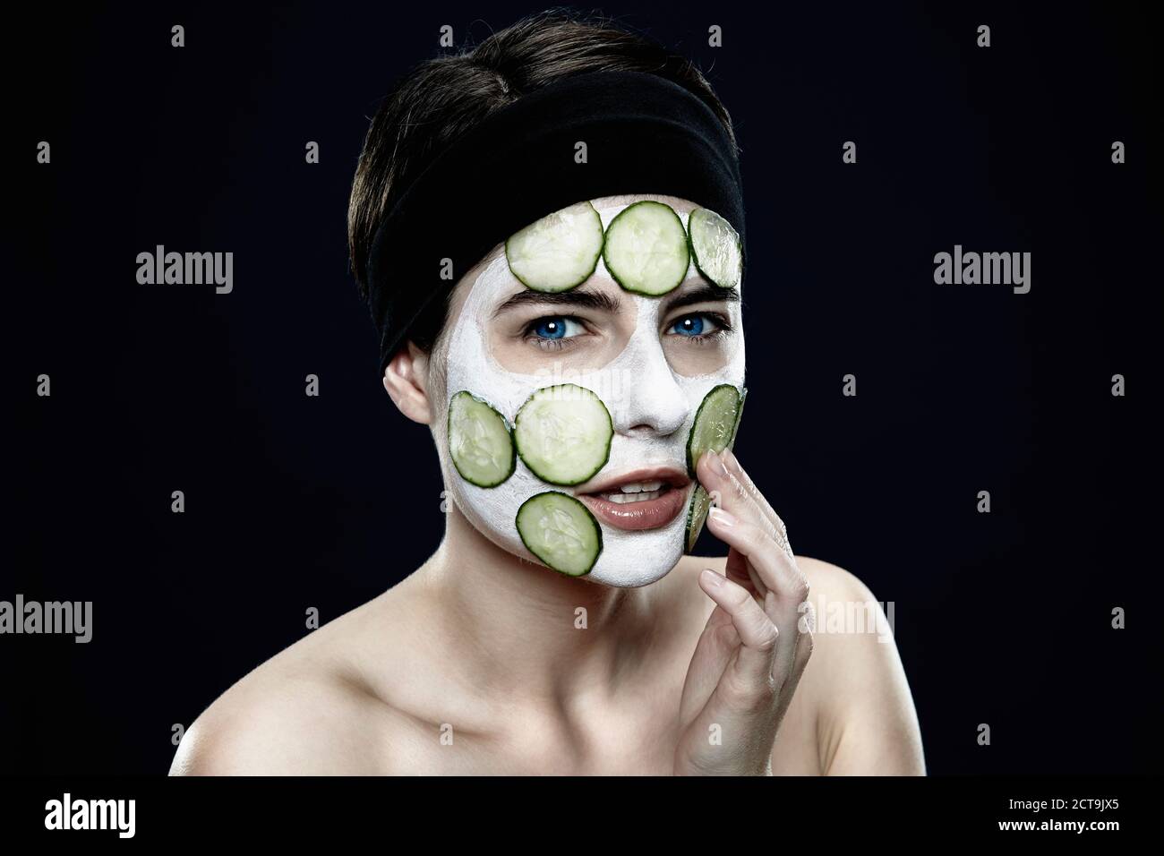 Portrait of young woman with zinc clay mask, close up Stock Photo