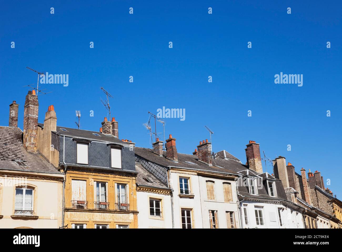 France, Champagne-Ardenne, Ardennes, Sedan, house roofs and chimneys in front of blue sky Stock Photo