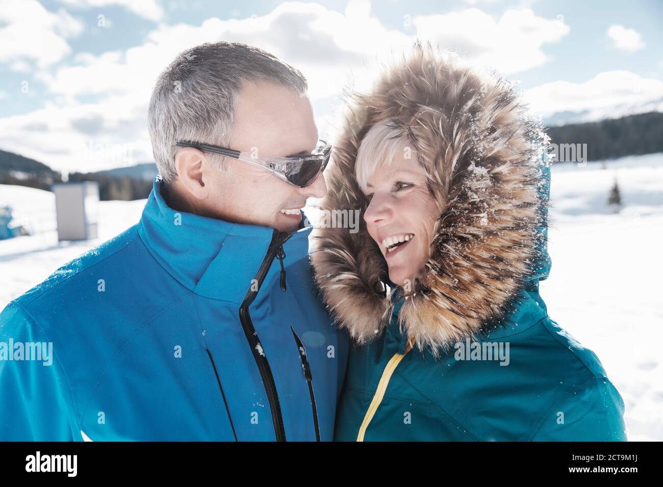Germany, Bavaria, Winklmoosalm, Smiling mature couple in snow Stock Photo