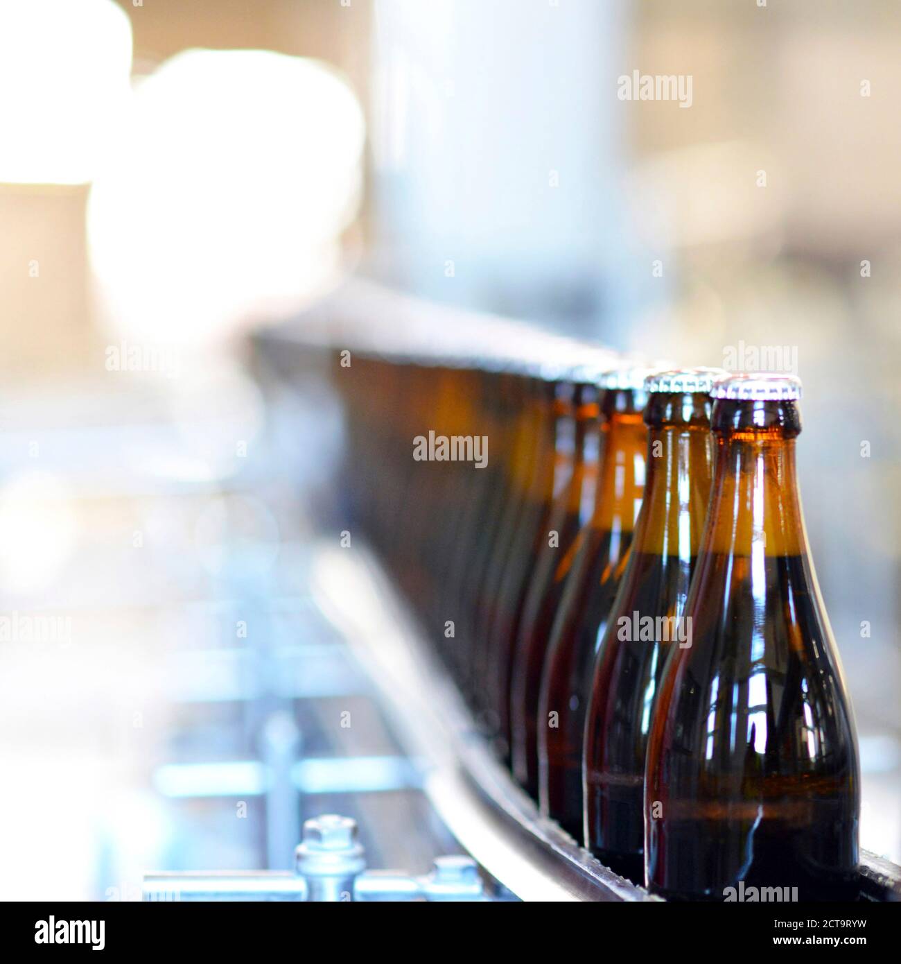 Germany, beer bottles on an assembly line of a bottling plant of a