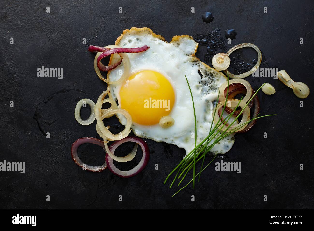 Fried egg, onions, chives Stock Photo