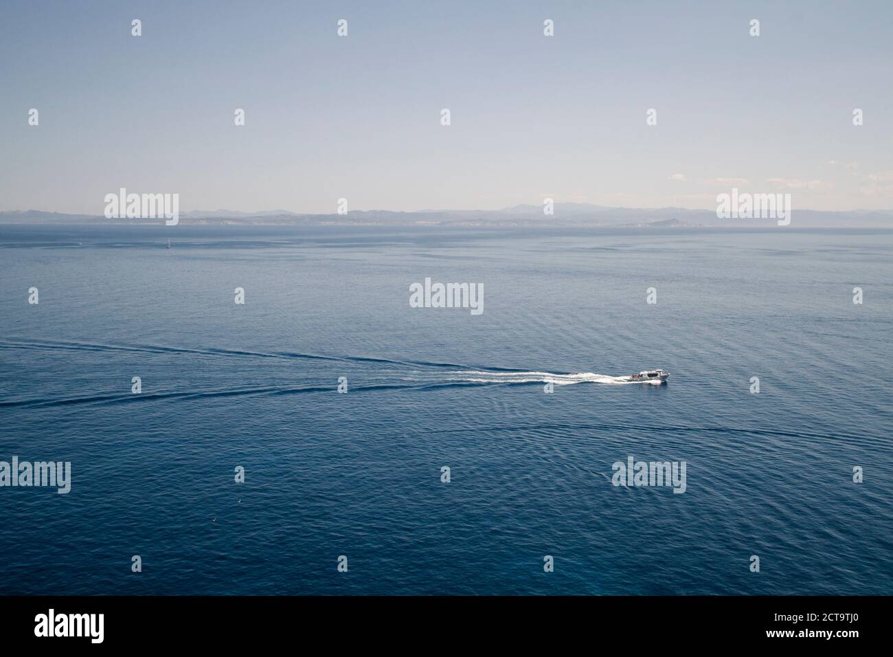 France, Corsica, Mediterranian Sea, view from Bonifacio, Boat in front of Sardinia Coastline Stock Photo