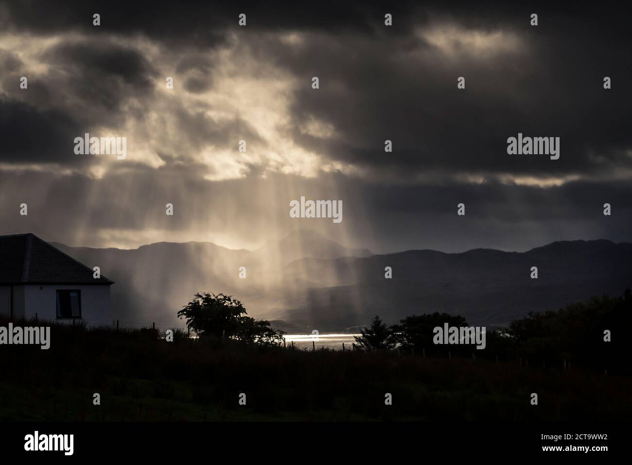Scotland, Isle of Skye, Sun rays shining through thunder clouds Stock Photo