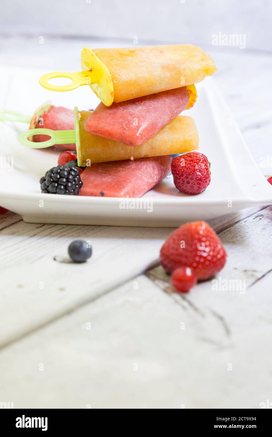 Homemeade flavoured ice with berries on wooden table, close up Stock Photo