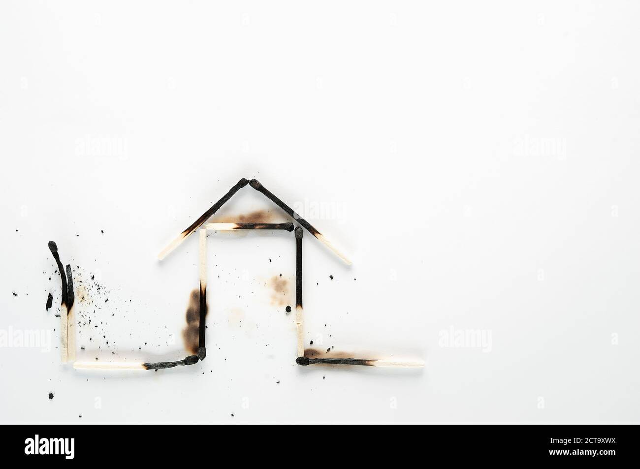 Burnt down matches shaped like a house Stock Photo