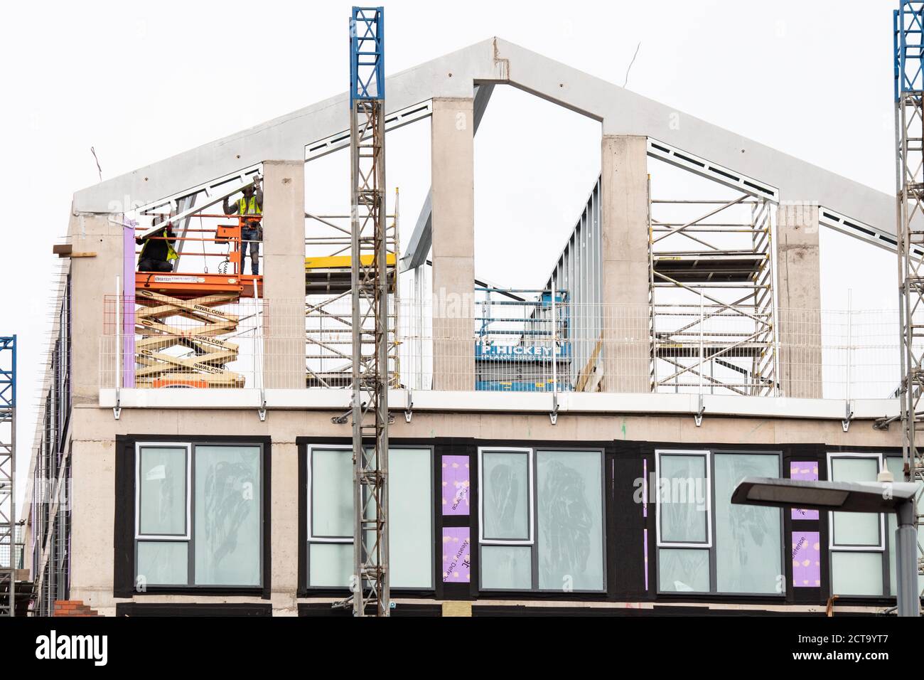 Two workmen installing a roof section in a building in Shadwell Street, near Birmingham City Centre. Stock Photo