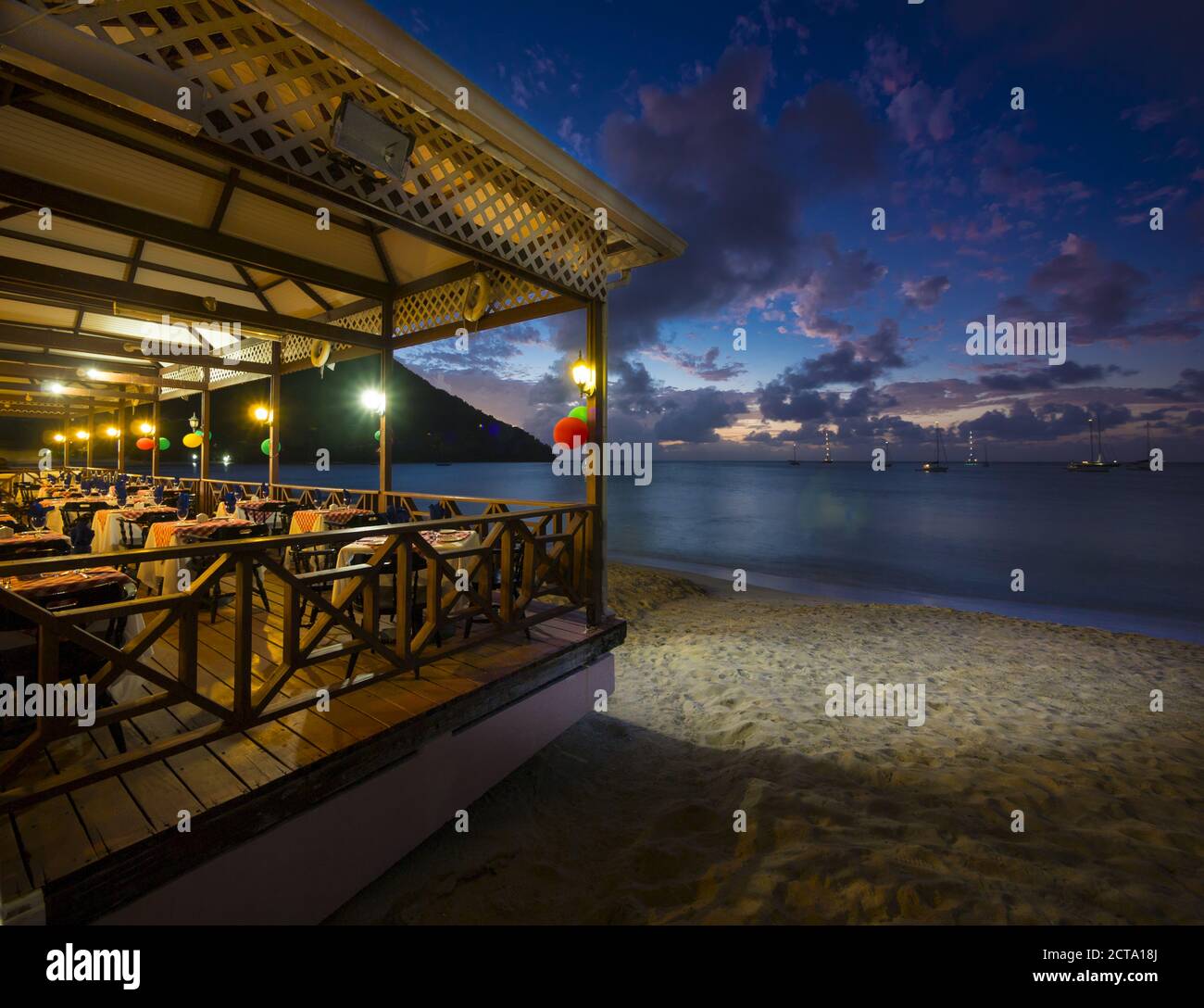 Caribbean, Lesser Antilles, Saint Lucia, restaurant at beach, Rodney Bay at dusk Stock Photo