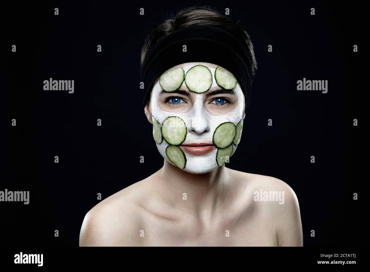 Portrait of young woman with zinc clay mask, close up Stock Photo