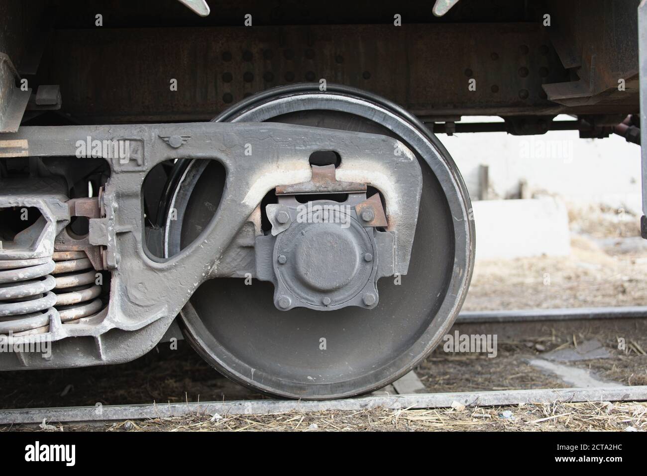 wheel mechanism of modern train locomotive on tracks. Steampunk, techno concept. Railroad transport, travelling, steel constructions Stock Photo