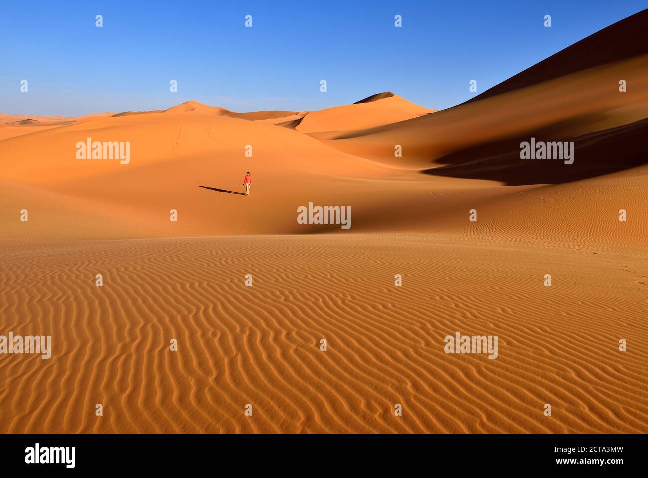 Africa, Algeria, Sahara, Tassili N'Ajjer National Park, Sand dunes of Tehak, One woman in the desert Stock Photo