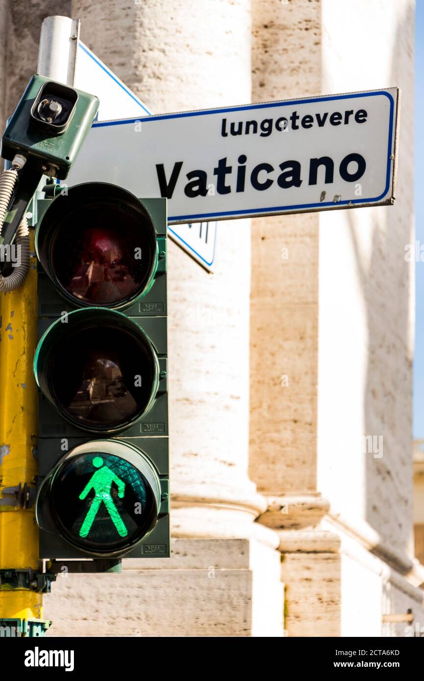 Italy, Rome, Green traffic light and road sign in Vatican City Stock Photo