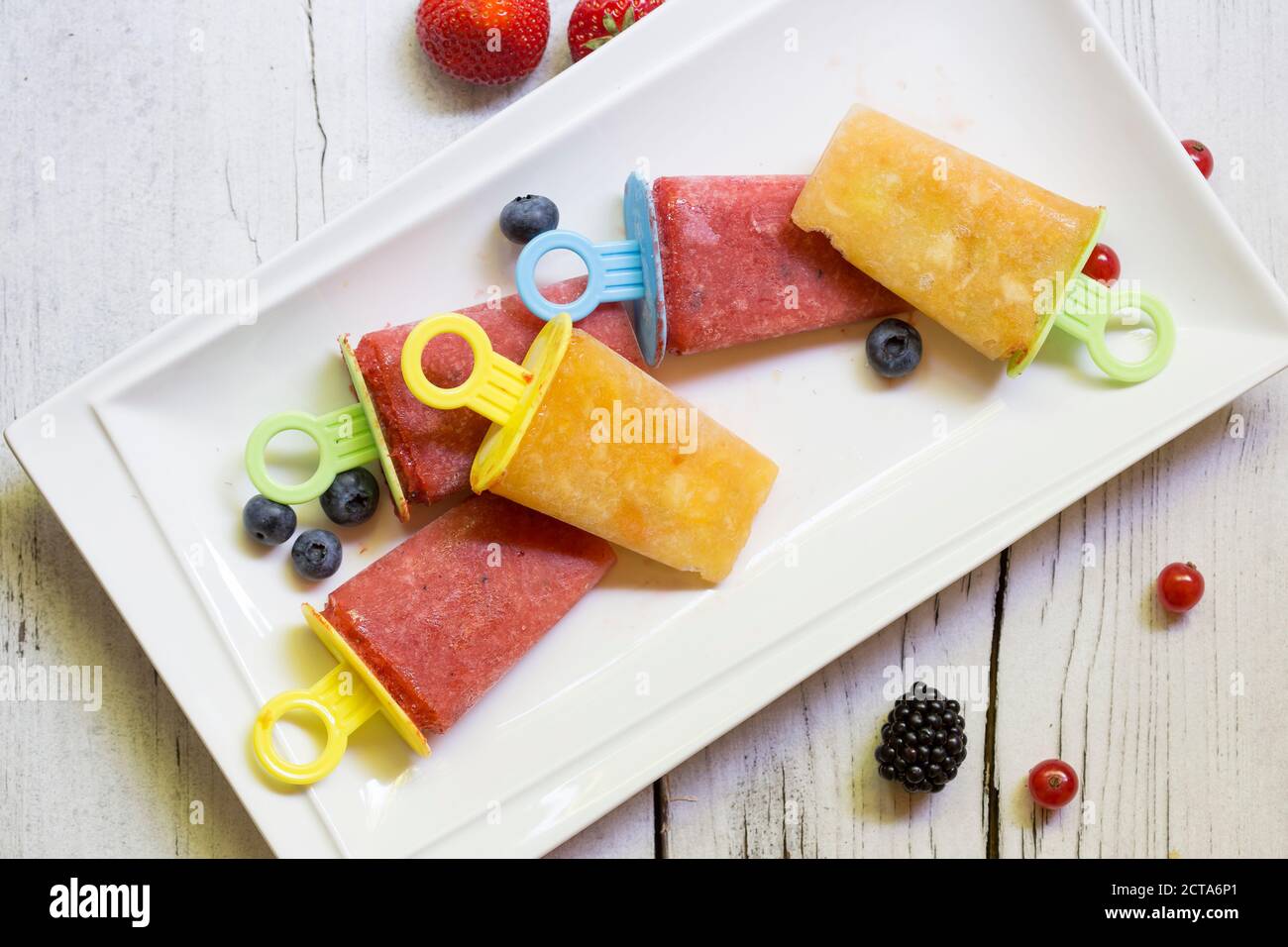 Homemade flavored ice with berries on wooden table, close up Stock Photo