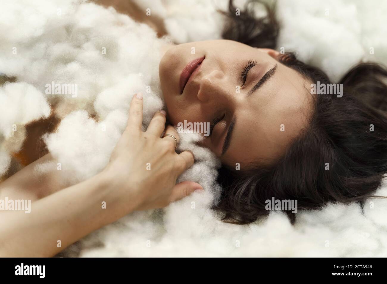 beautiful brunette woman sleeping in the clouds Stock Photo - Alamy