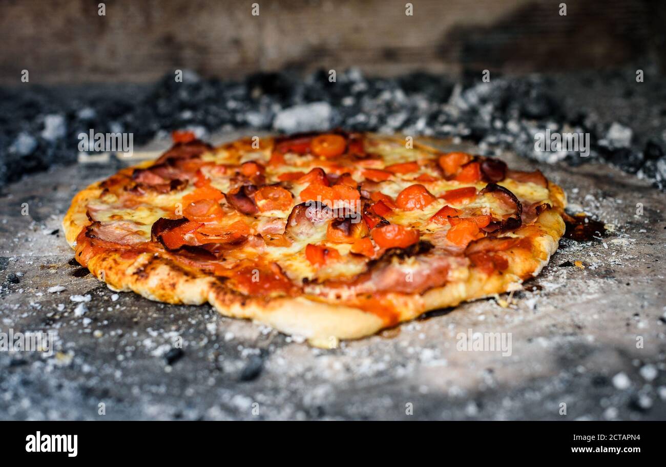 Making of homemade Italian pizza in fireplace brick oven. Making of