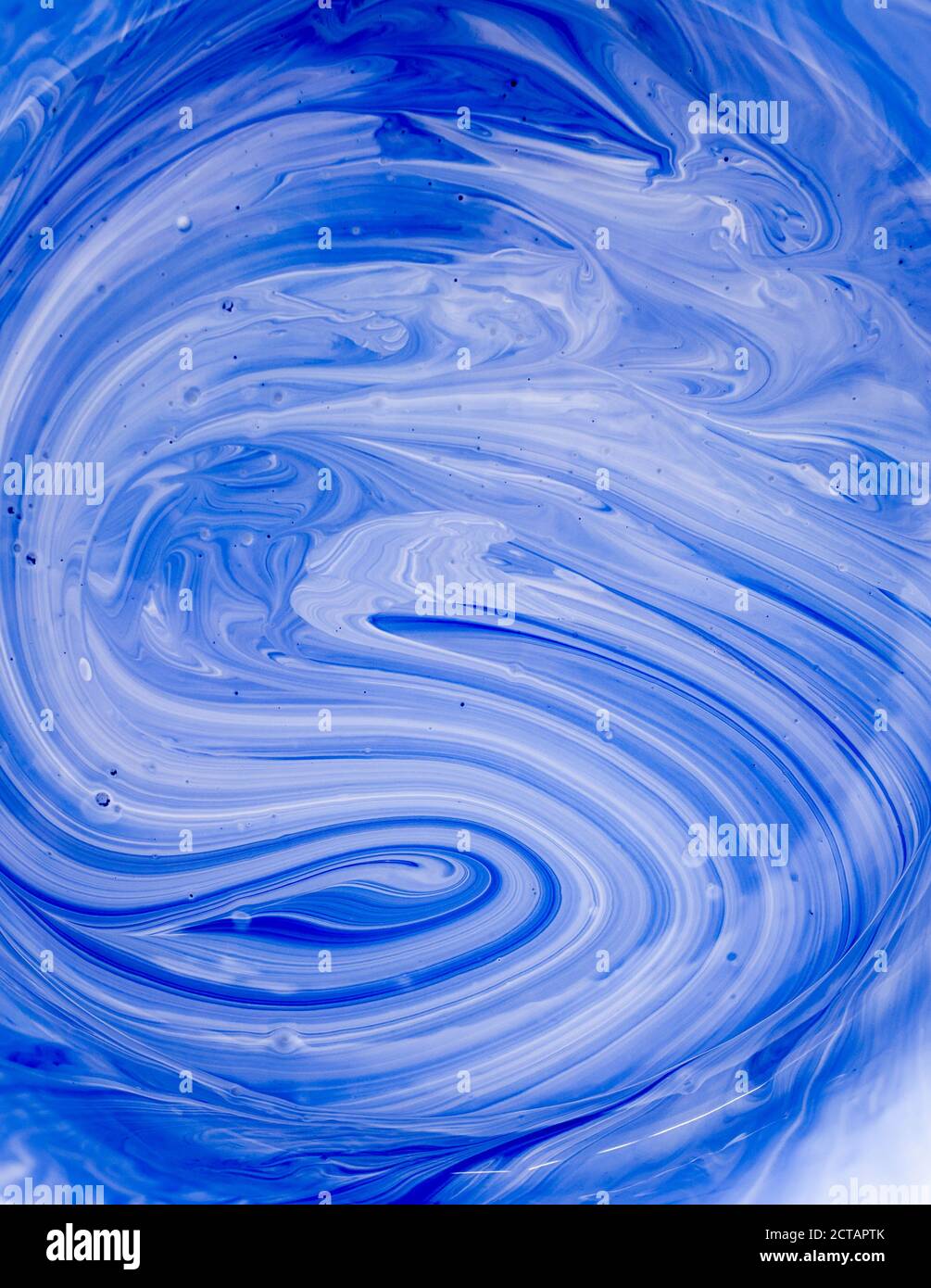 Mixing white and blue paints Contemporary art. Bright abstract background with space for text