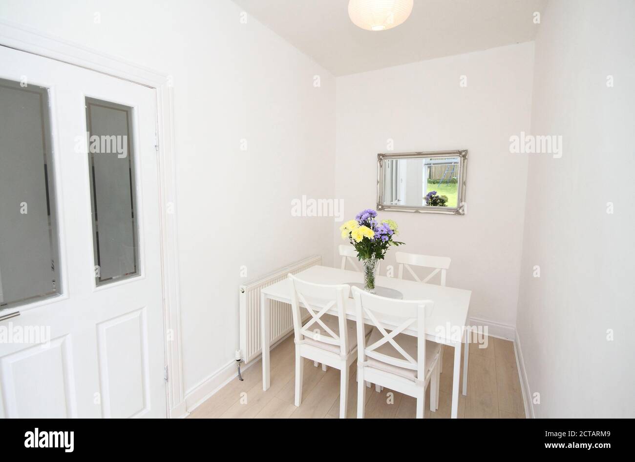 dining room with white table, chairs and walls Stock Photo Alamy