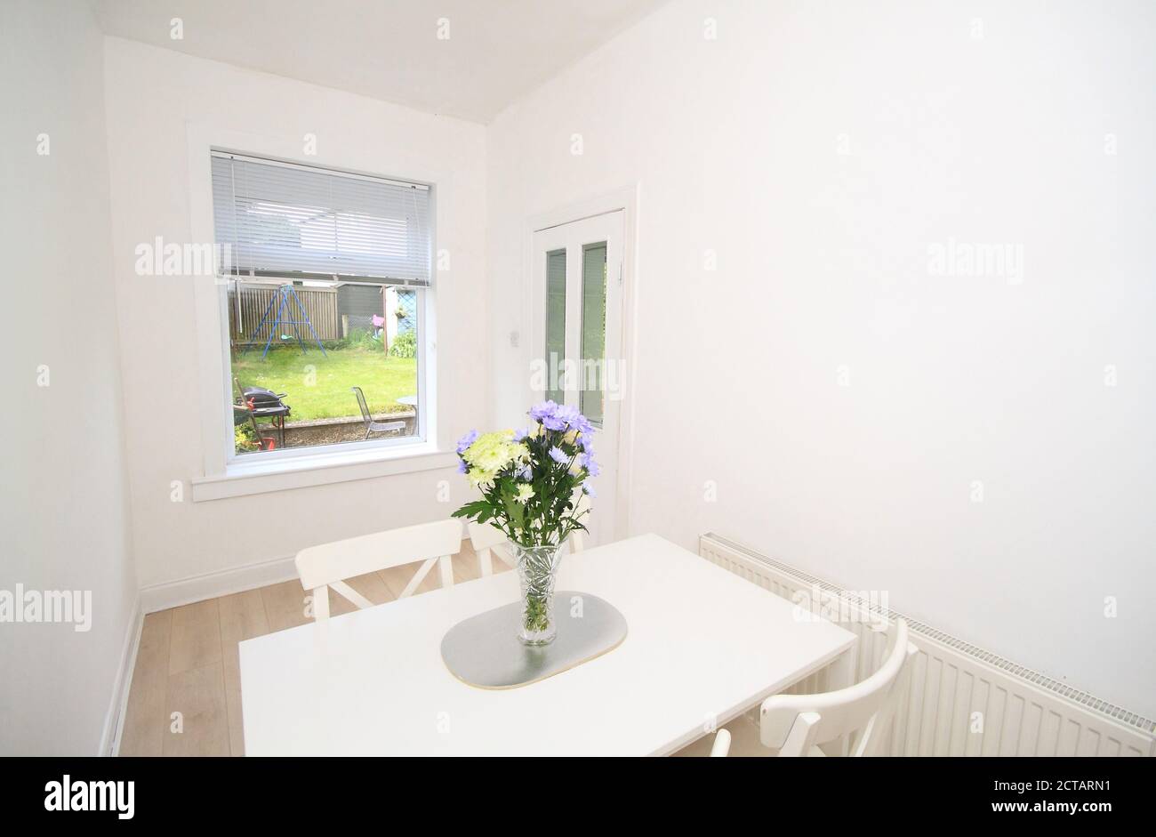 modern dining room with white table, chairs and walls Stock Photo Alamy