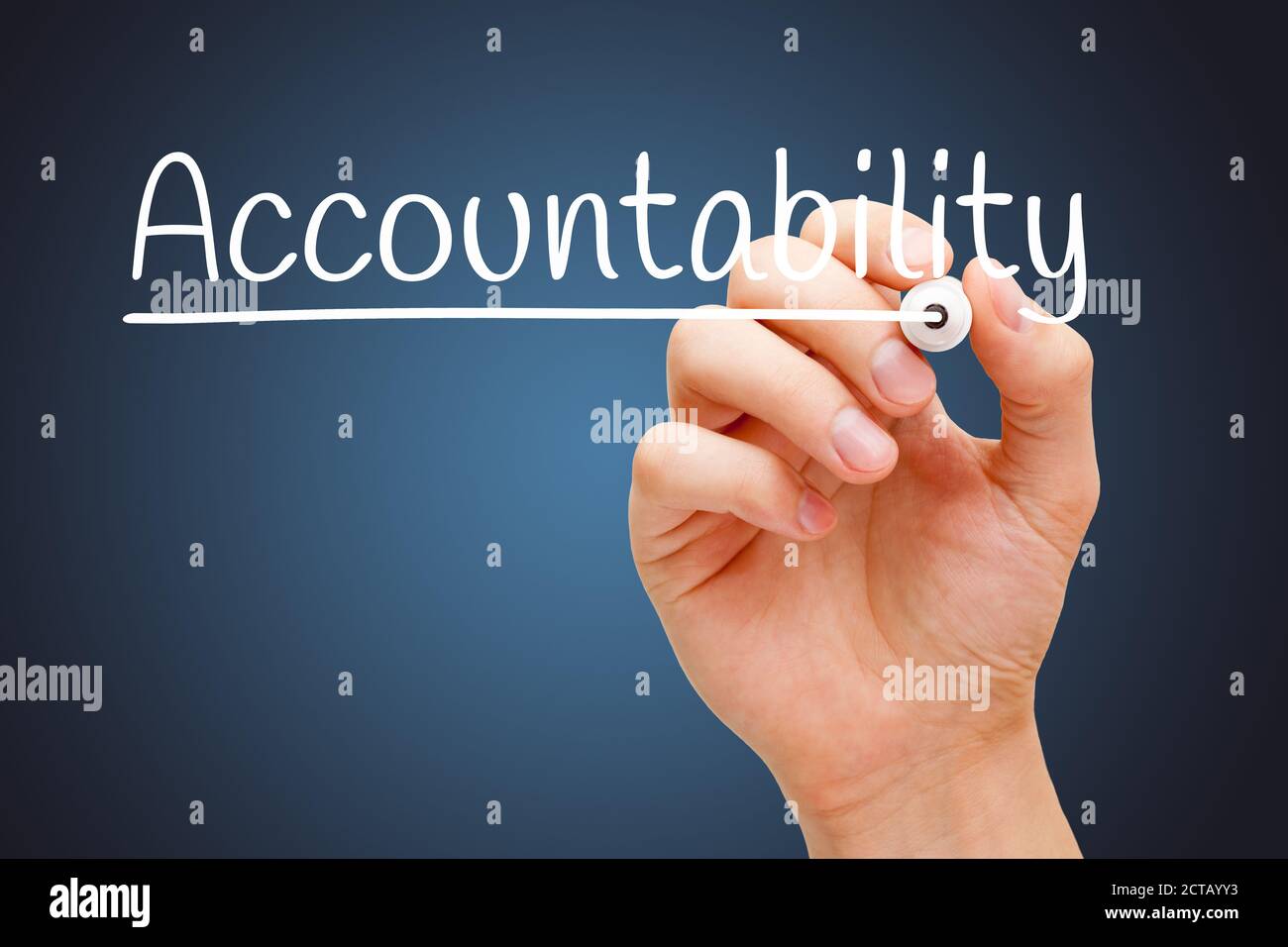 Hand writing the word Accountability with white marker on transparent wipe board over dark blue background. Stock Photo