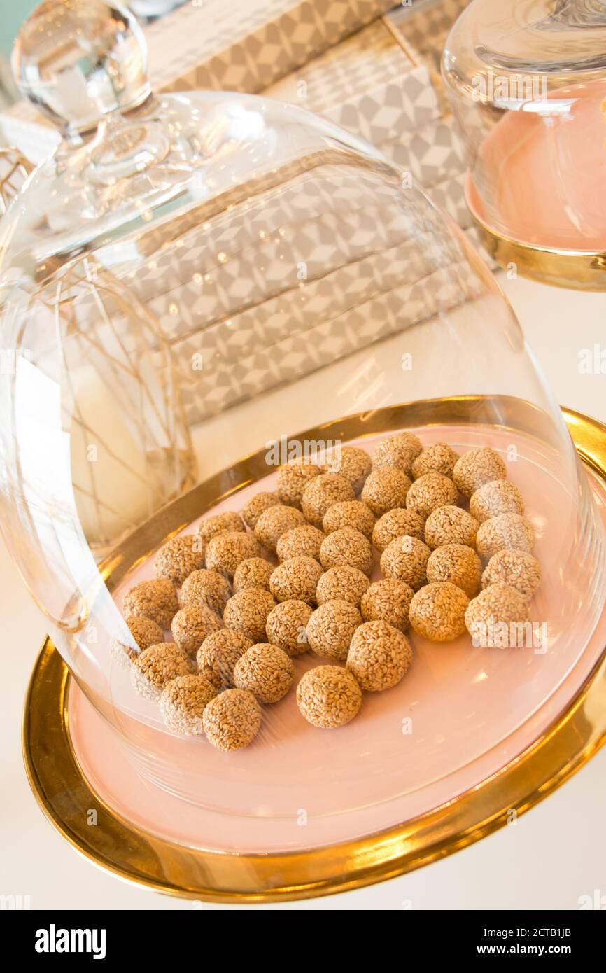 Traditional arabic sesamy balls served under a glass cupole at a luxourious restaurant serving tradtitional Kuwaiti food. Stock Photo