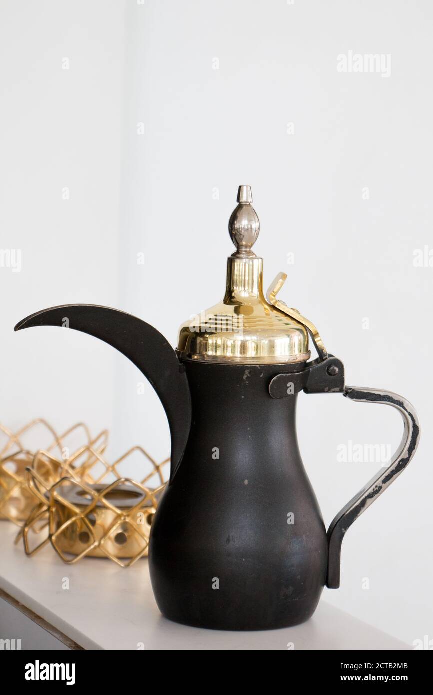 A coffee pot in black and gold from a luxourious restaurant serving tradtitional Kuwaiti food. Stock Photo