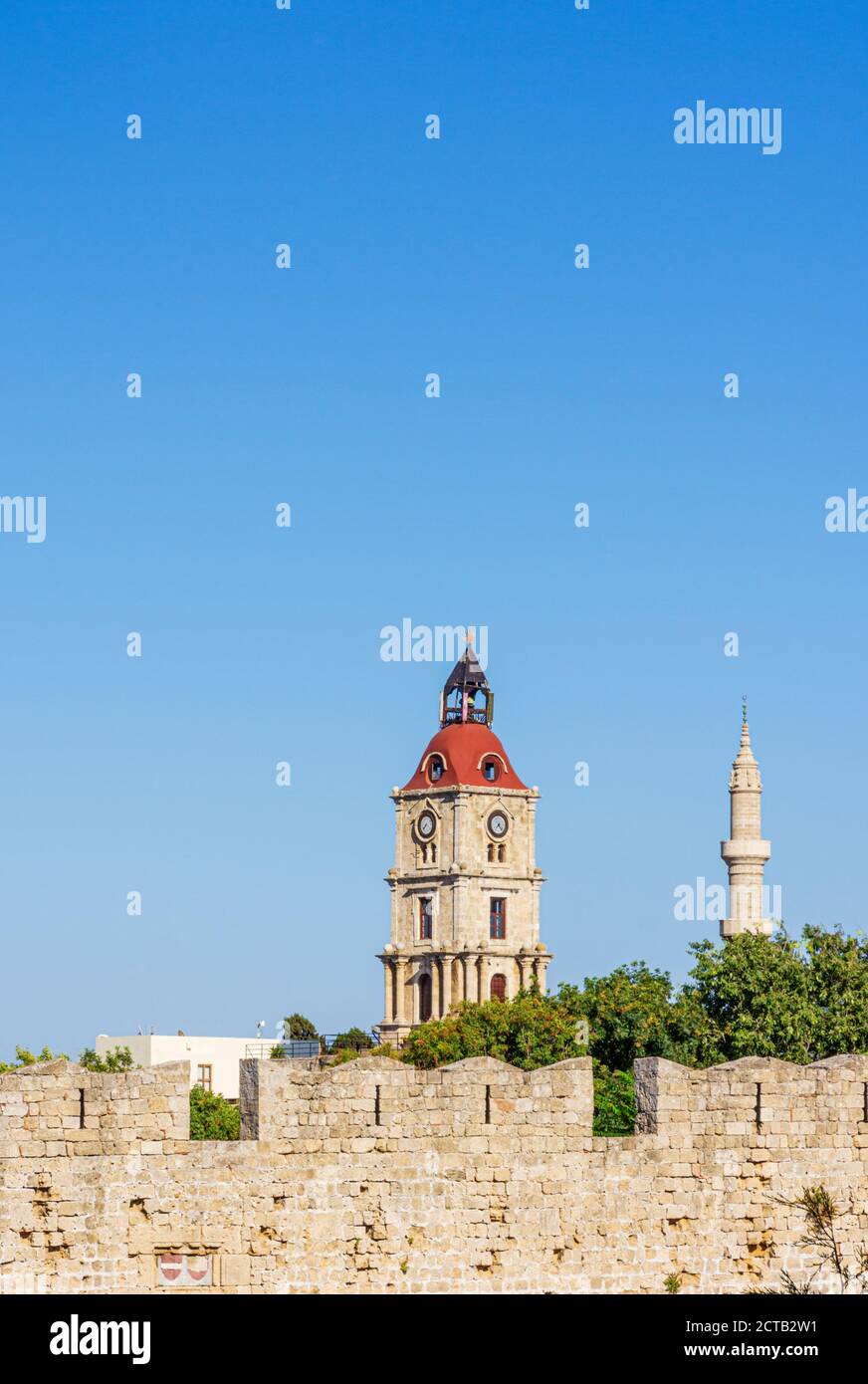 Medieval Clock Tower and Minaret of the Mosque of Suleiman in old Rhodes Town, Greece Stock Photo