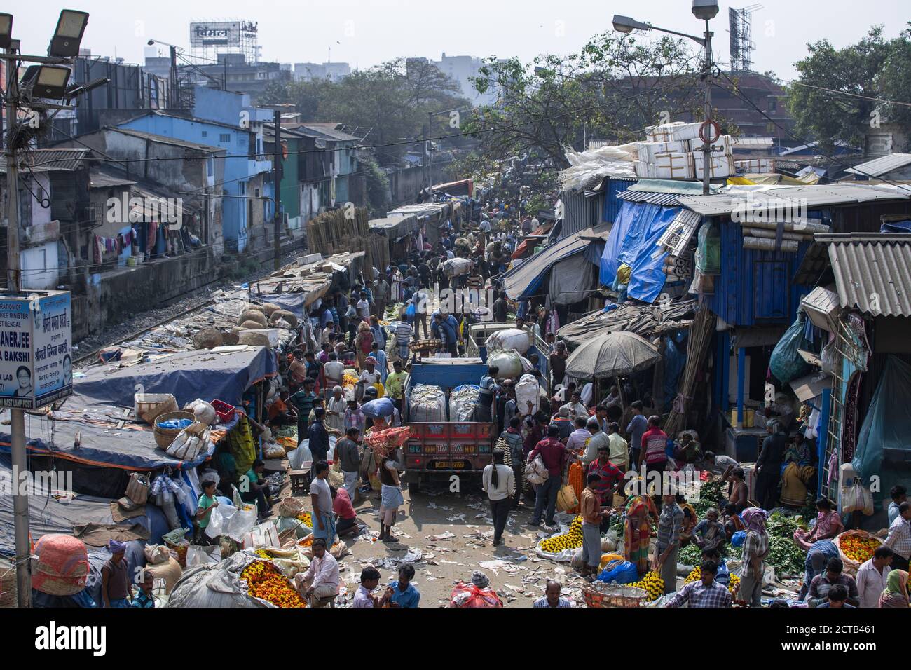 Kolkata, India - February 2, 2020: Unidentified people attends Mallick Ghat flower market by Howrah bridge next to a railroad on February 2, 2020 Stock Photo
